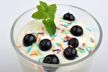 some organic blackberries in natural yoghurt and mint