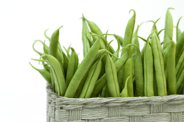 Close up of green beans  and wicker basket