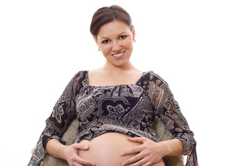 pregnant woman  smiles on a white background