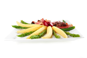 meat served on white with corns