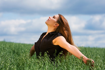 Happy young woman relaxing on nature.