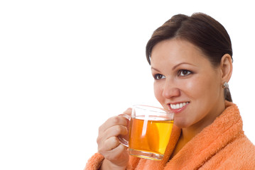 pregnant woman drinking in an orange smock with a white