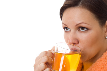 pregnant woman drinking tea in an orange smock with a white back