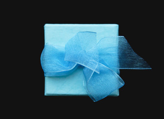 The gift in the blue box on the black background