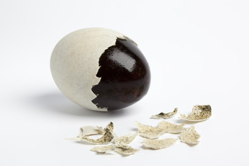 Thousand years old duck egg with pieces of the egg-shell