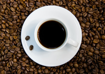 White coffee cup on the beans.