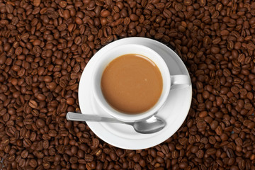 Fototapeta premium Cup with coffee, costing on coffee grain