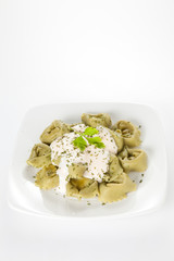 dish of tortellini with cheese sauce