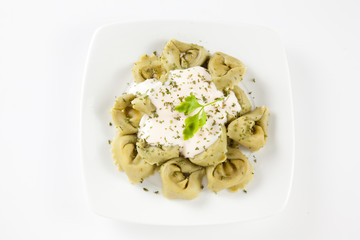 dish of tortellini with cheese sauce