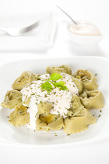 dish of tortellini with cheese sauce