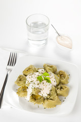 dish of tortellini with cheese sauce