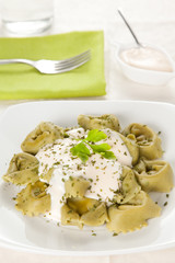 dish of tortellini with cheese sauce