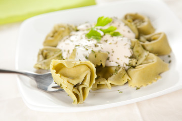 dish of tortellini with cheese sauce