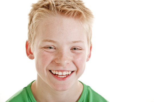 Happy smiling 12 year old boy isolated on white background