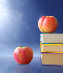 Apples with books in blue background