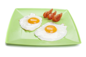 Fried eggs on green plate