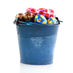 Old blue bucket with easter eggs