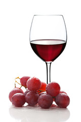 glass of red wine and grapes isolated