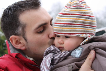 Father kissing son