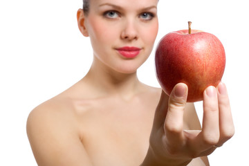 beautiful young blonde woman offering red apple, focus on apple