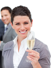 Charming businesswoman toasting with Champagne