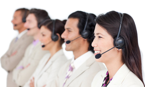 Positive business team with headset on standing in a row
