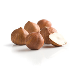 Pile of peeled hazelnuts over white background