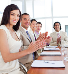 Multi-ethnic business team applauding after a conference