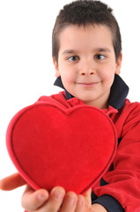 adorable little boy giving his red heart.