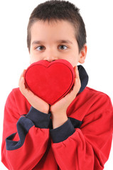 An adorable little boy giving his red heart.