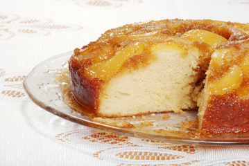 sliced upside down pear cake on glass plate