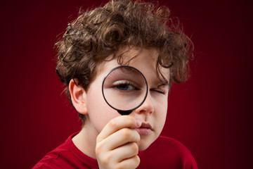 Boy using magnifying glass