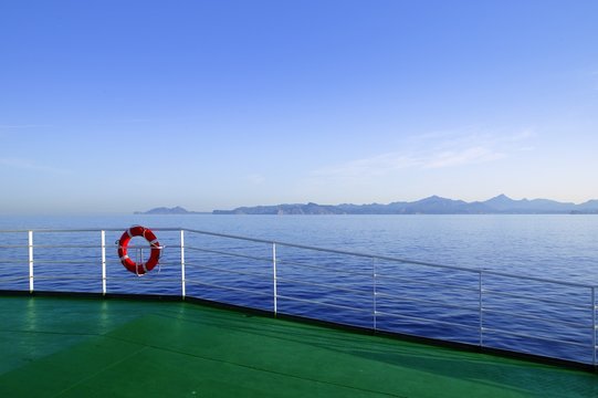 Boat green deck with Ibiza island mountains