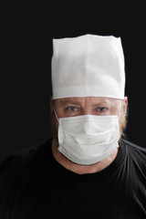 Portrait of an evil doctor in a mask on the black background