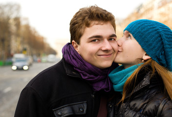 Happy couple in love kissing on the street