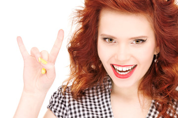 happy teenage girl showing devil horns gesture