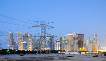 Obraz premium Electrical Tower and Dubai City, United Arab Emirates