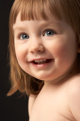 Close Up Studio Portrait Of Smiling Young Girl