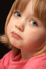 Close Up Studio Portrait Of Sad Young Girl
