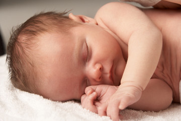 Close Up Of Baby Sleeping On Towel