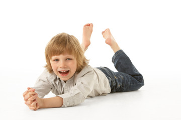 Young Boy Lying On Stomach In Studio