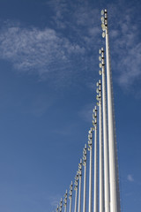 Stadium light pole, blue sky a few clouds