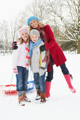 Fototapeta na wymiar Mother with children in Snowy Landscape