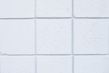 Closeup of the white tiled wall of a house