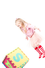 Little girl playing with cube