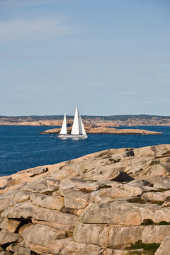Sailboat and rocky coast