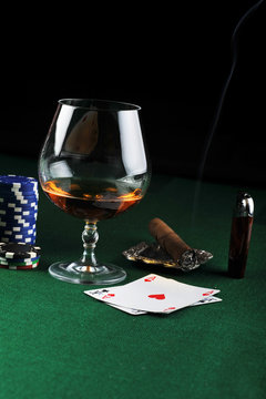 drink and playing cards on green