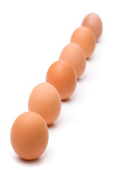 Six eggs lined up diagonally with ample space for copy