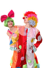 Two clown-girls in wigs and fancy costumes