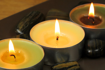 Three candles and stones